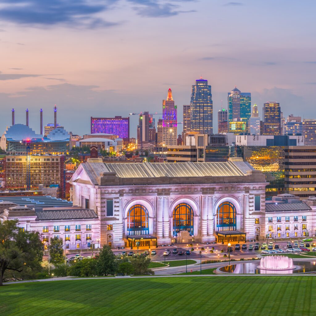 Kansas City, Missouri, USA downtown skyline with Union Station at dusk.